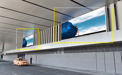三亚机场一层综合体南侧通道，正对机场灯箱广告